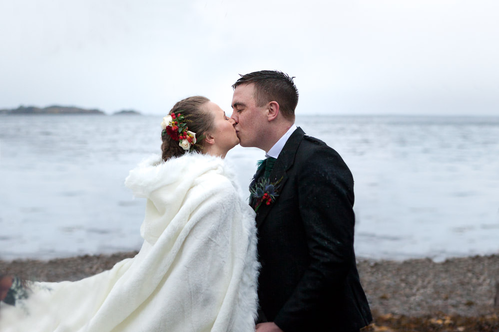 Bride and groom share first kiis at their beach ceremony at Isle of Skye Wedding